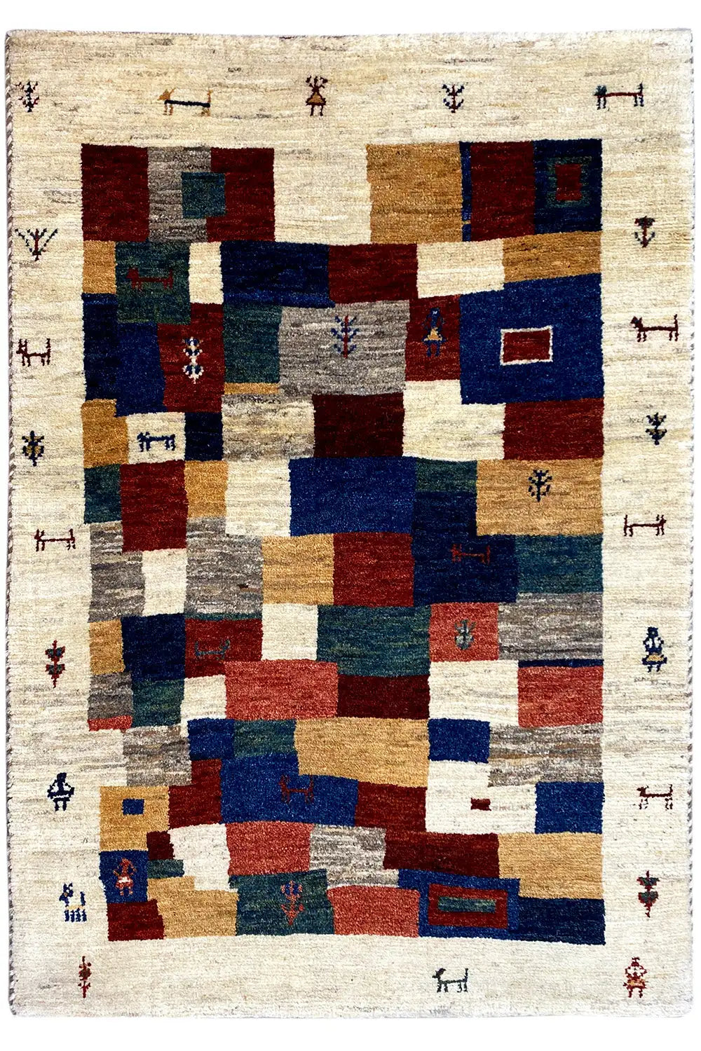 Gabbeh rug with geometric patchwork, beige base, red and blue elements.