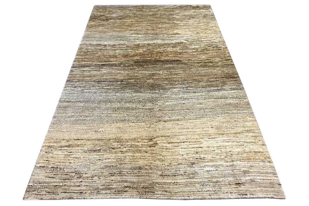 Gabbeh rug front viewed at an angle: light beige surface with gray-brown stripes
