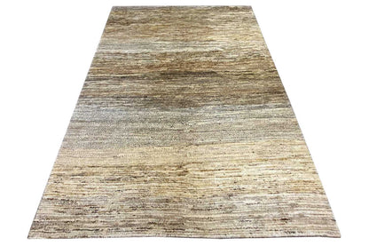 Gabbeh rug front viewed at an angle: light beige surface with gray-brown stripes