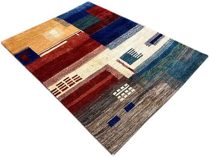 Gabbeh rug with patchwork sections and symbolic motifs in red, blue, and beige