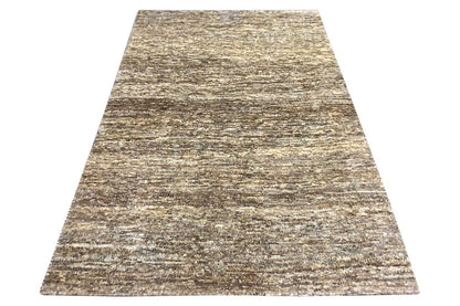 Gabbeh rug, flared trapezoidal shape: mottled beige-gray-brown textured pattern