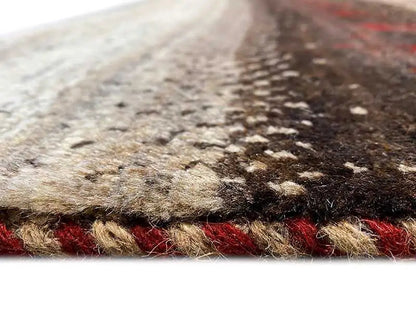Gabbeh rug close-up: woven pile fibers, beige border, and red accents