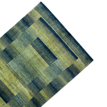 Green gabbeh rug detail: horizontal and vertical rectangular shapes in a grid.