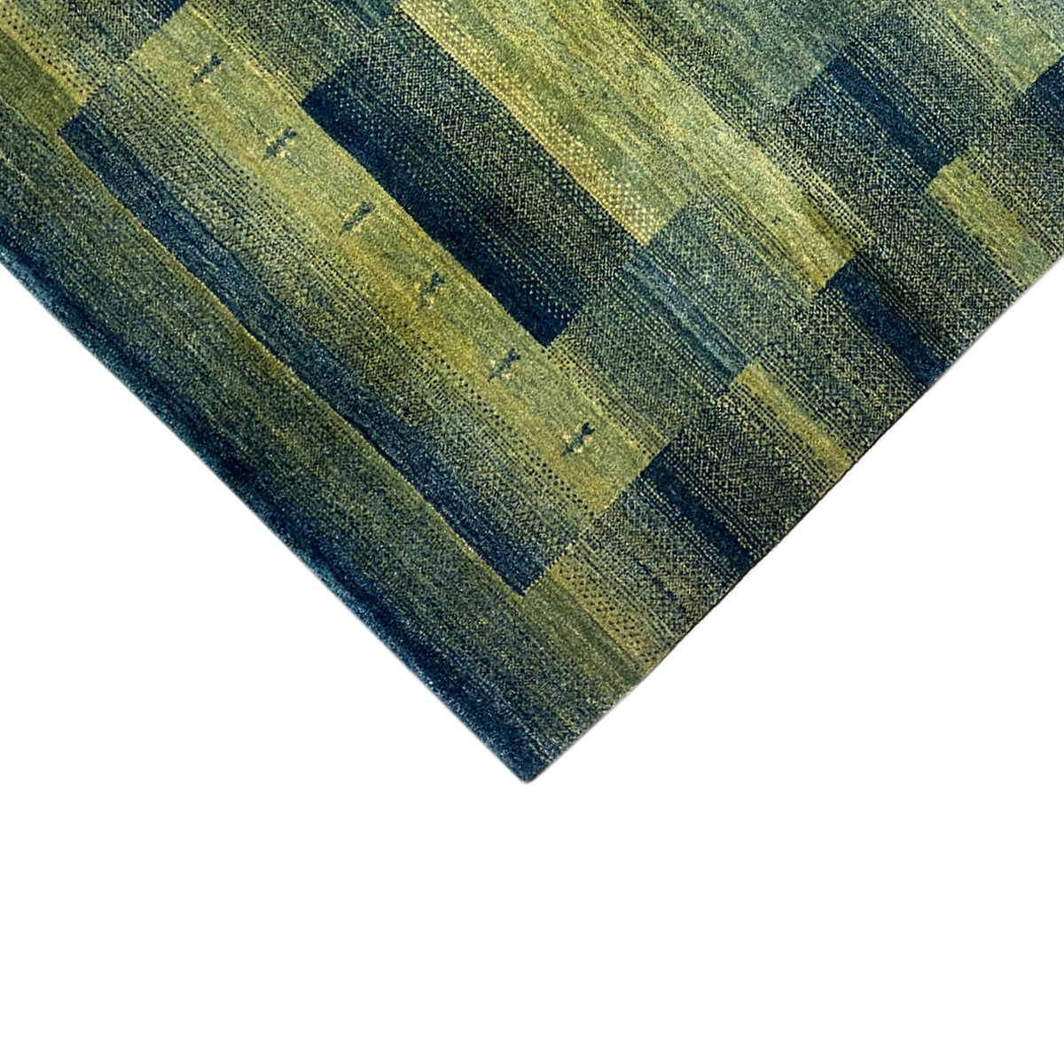 Gabbeh rug green detail: diagonal pattern of rectangular sections and lines.