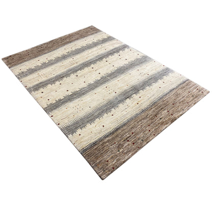 Gabbeh rug laid diagonally, beige base with gray stripes and brown areas