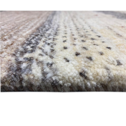 Close-up of a Gabbeh rug with a short pile, a beige-gray pattern, and dark dots