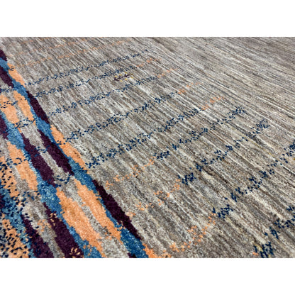 Close-up of a Gabbeh rug: gray pile texture with blue-orange lines