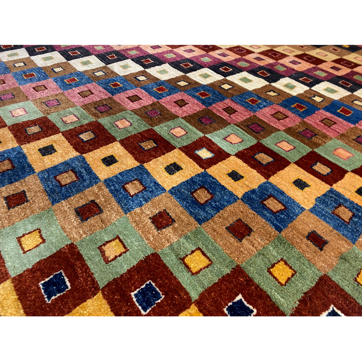 Gabbeh rug close-up: many colorful squares in shades of blue, red, and green