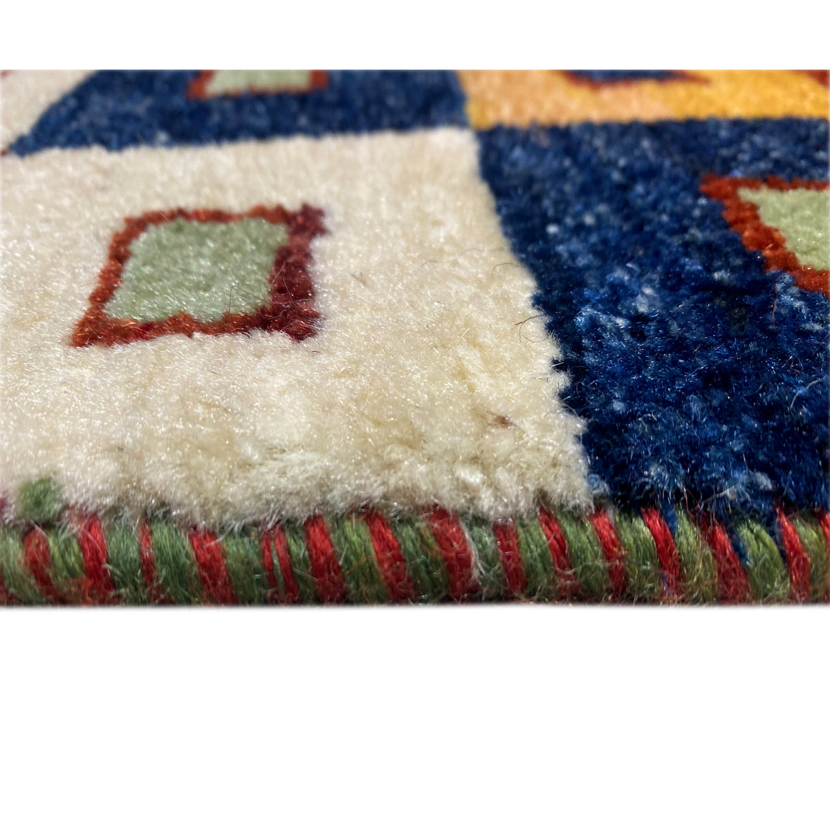 Gabbeh rug detail with pile and colorful fringe along the edge