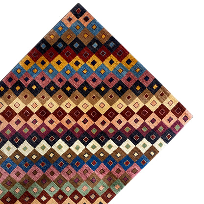 Gabbeh rug corner with a colorful square pattern, arranged diagonally
