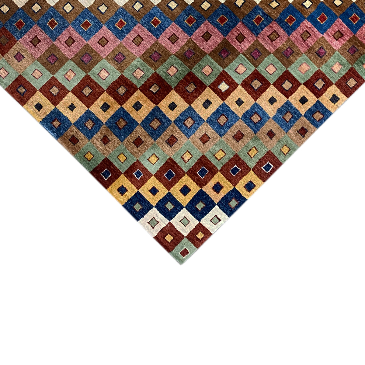 Gabbeh rug corner with a dense square pattern in blue, red, and green