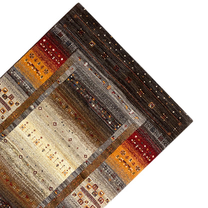 Gabbeh rug in oblique view: border panels in brown, orange, and beige