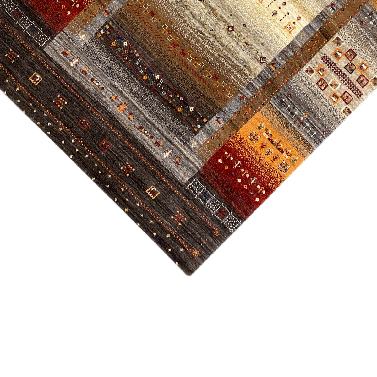 Corner of the Gabbeh rug with geometric patterns in dark brown and orange