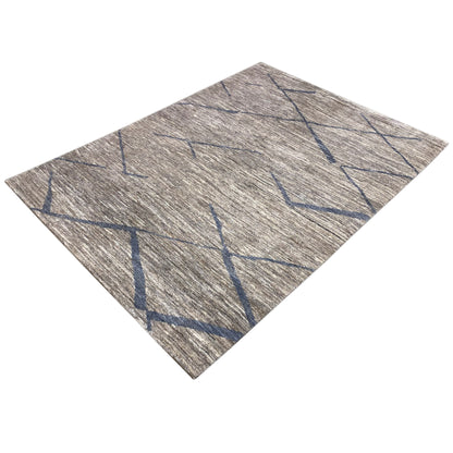 Gray Gabbeh rug with a blue line pattern, photographed at an angle