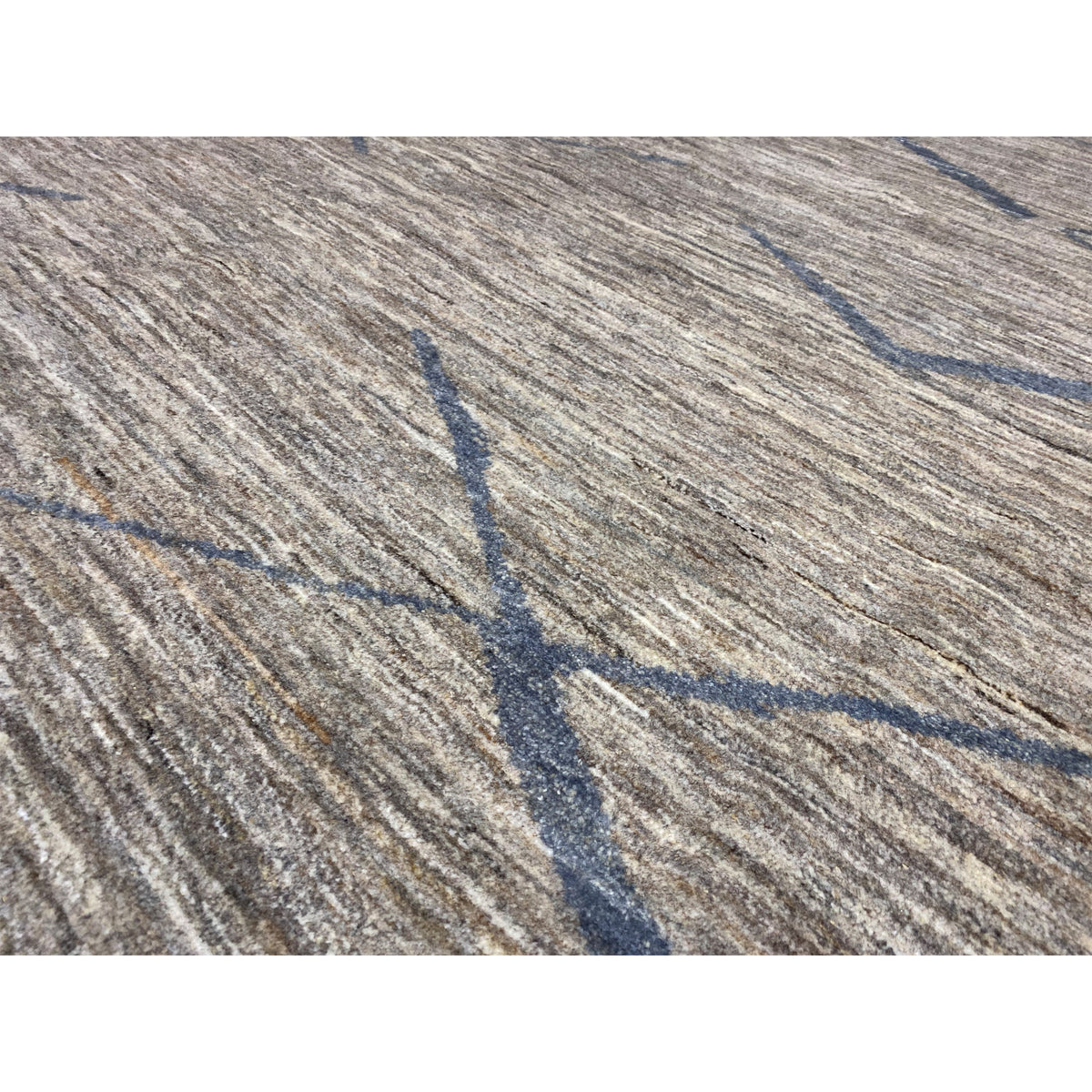 Close-up of a Gabbeh rug: woven gray texture with blue lines