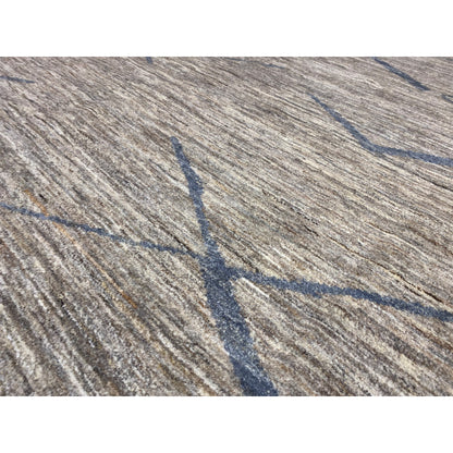 Close-up of a Gabbeh rug: woven gray texture with blue lines