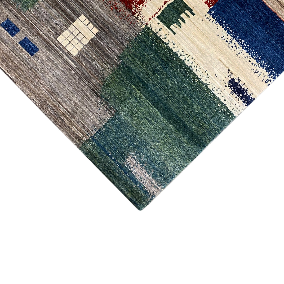 Gabbeh rug 205x154 cm Corner detail: gray, green, and cream-colored patterned blocks