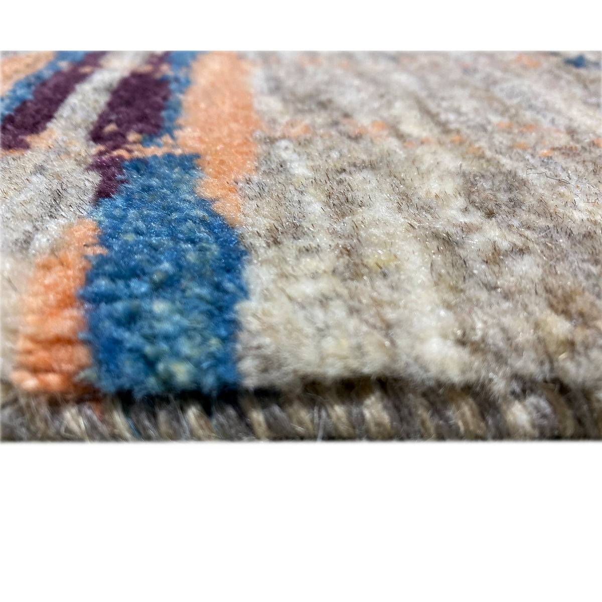 Texture close-up: dense gray pile with a blue and orange color gradient