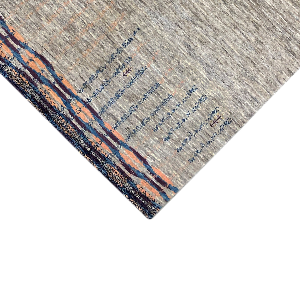 Gabbeh rug corner with a dark border, gray pile, and blue-orange lines in the pattern