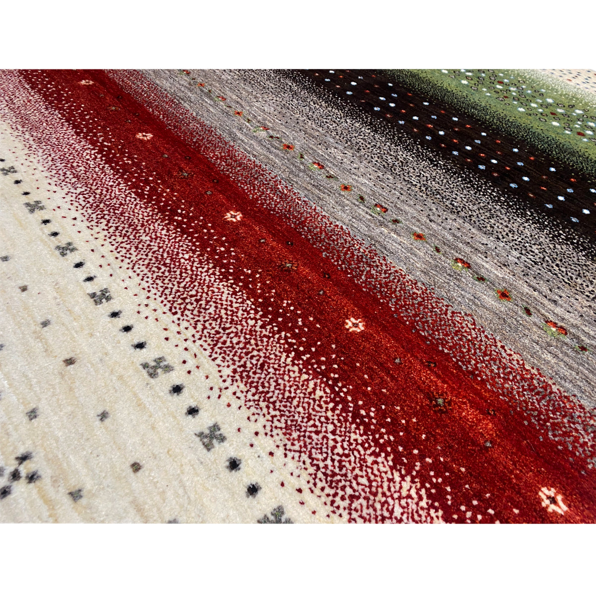 Close-up of a Gabbeh rug: red and gray stripes with fine dotted coloring