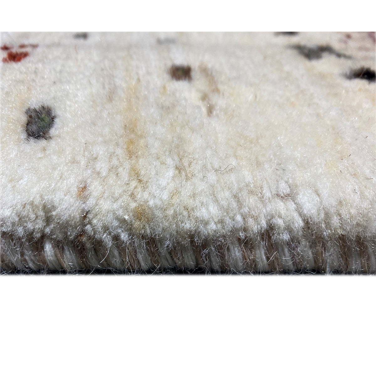 Close-up of the carpet pile: soft, light surface with dark accents