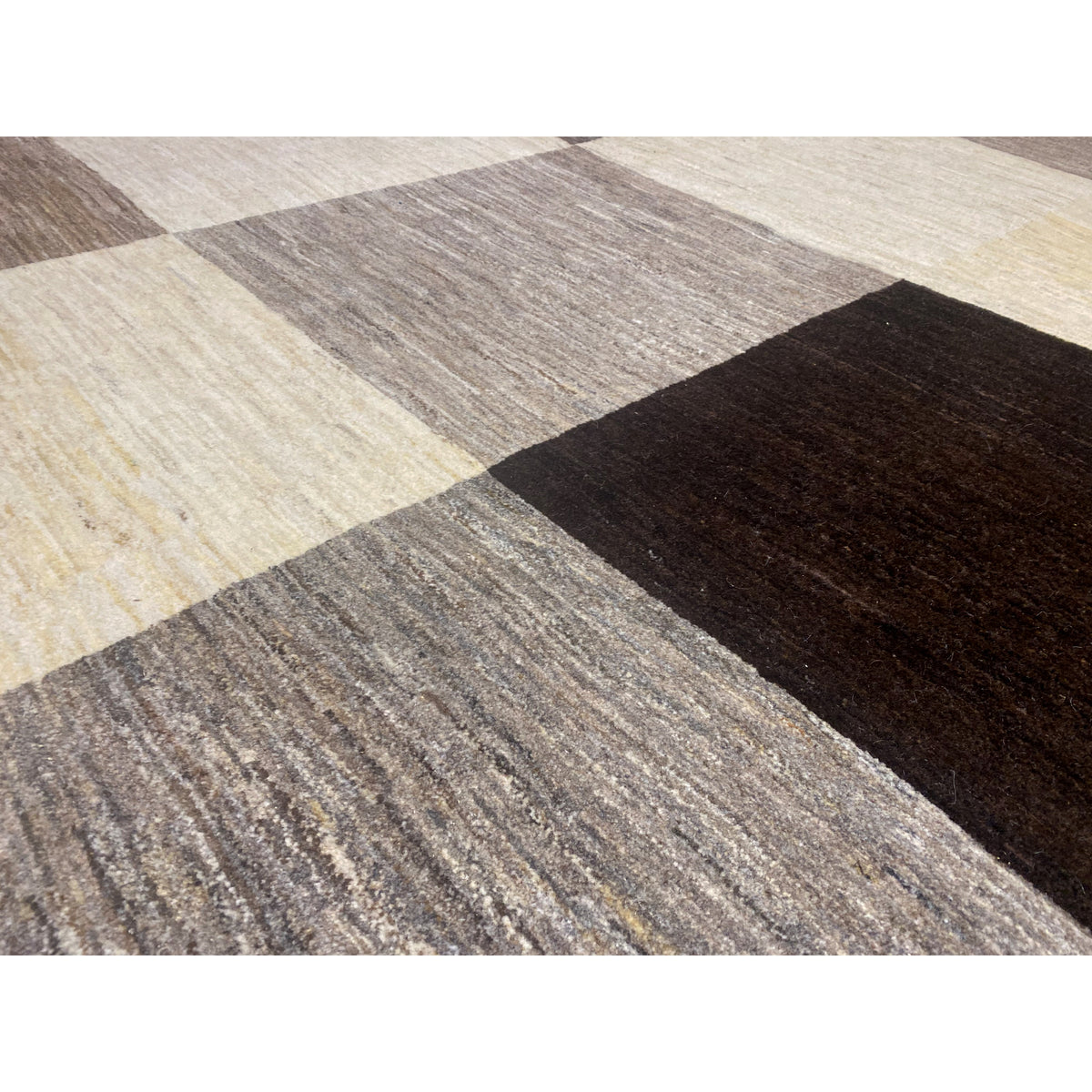 Gabbeh rug detail: textured pile in beige, gray, and dark block sections