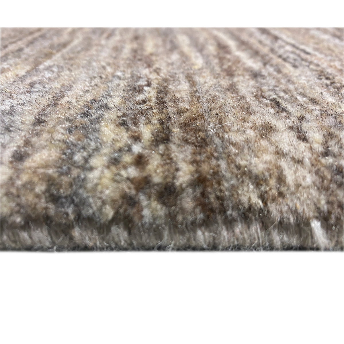 Gabbeh rug close-up of the pile: mottled pattern in beige, gray, and black