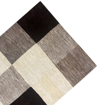 Gabbeh rug with a checkered pattern, beige central and gray border sections with black accents