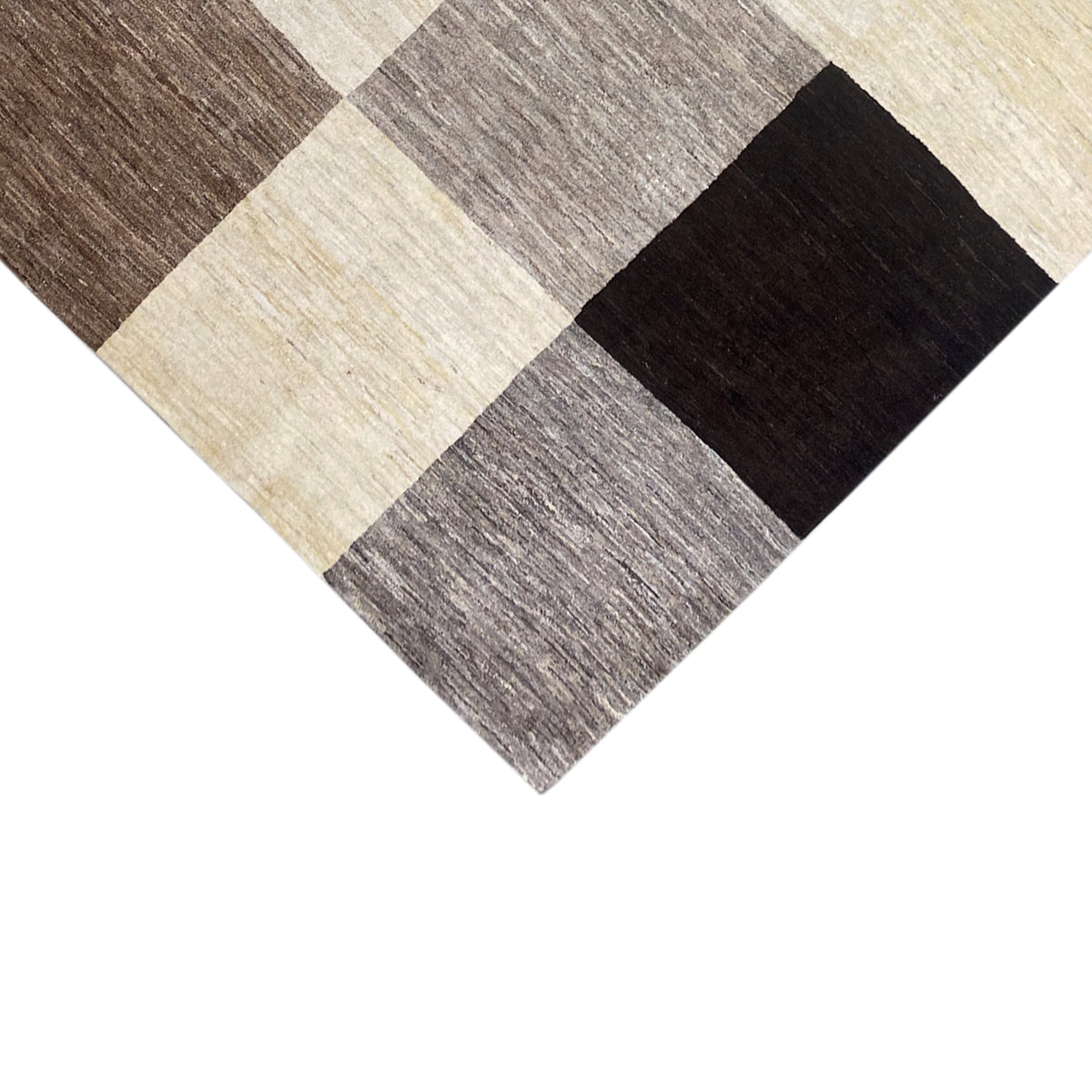 Gabbeh rug corner view with a checkered pattern of beige, gray, and black squares