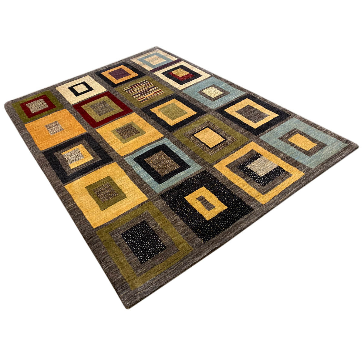 Gabbeh rug viewed from a diagonal perspective, many squares in yellow, brown, blue, and gray
