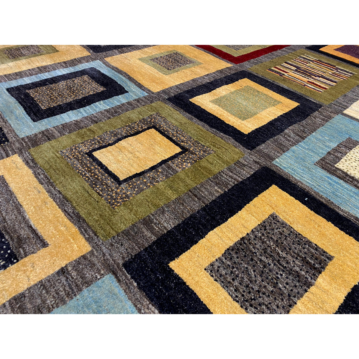 Gabbeh rug detail: woven squares with thread texture in yellow, blue, and gray