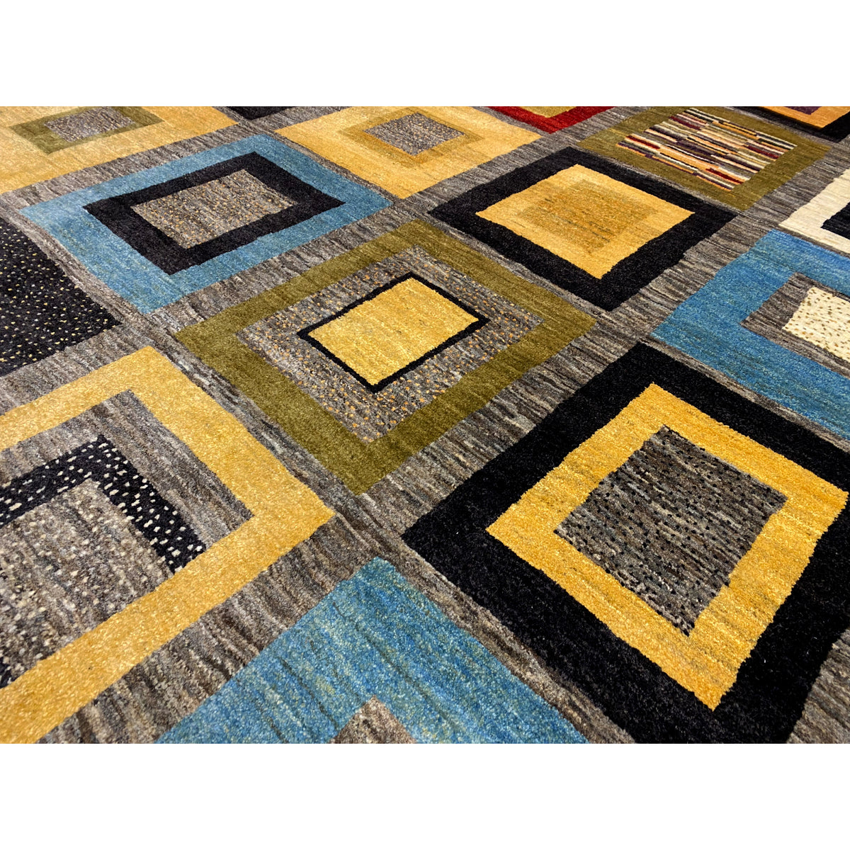 Close-up of a Gabbeh rug: woven squares with yellow, blue, and black accents