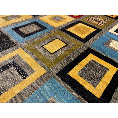 Close-up of a Gabbeh rug: woven squares with yellow, blue, and black accents