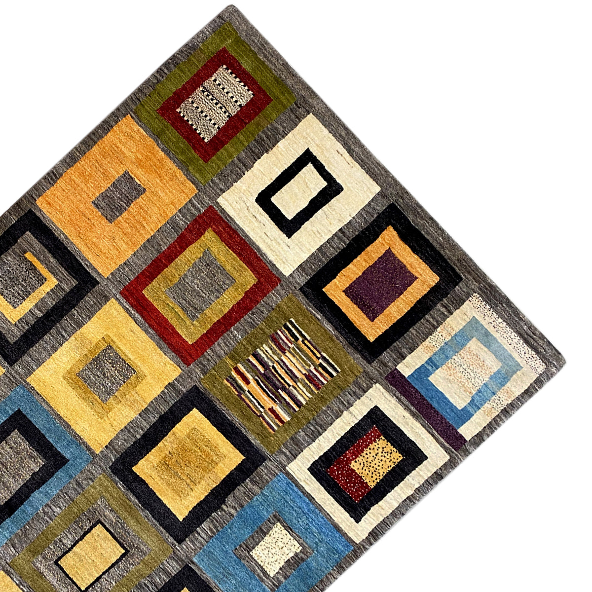 Gabbeh rug at an angle: colorful squares with fine line details and gray borders