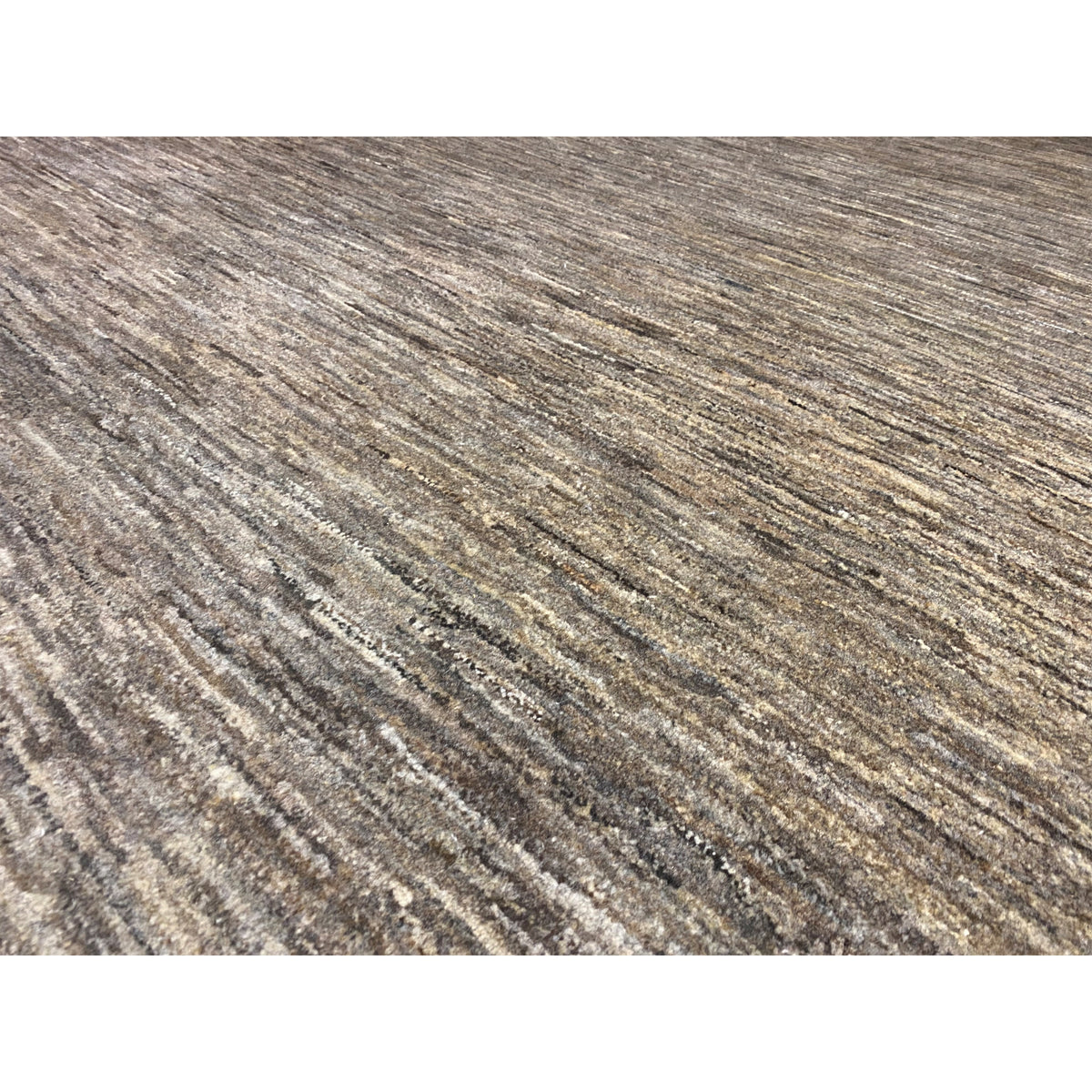 Detail Gabbeh rug: beige mottled pattern with a fine pile texture
