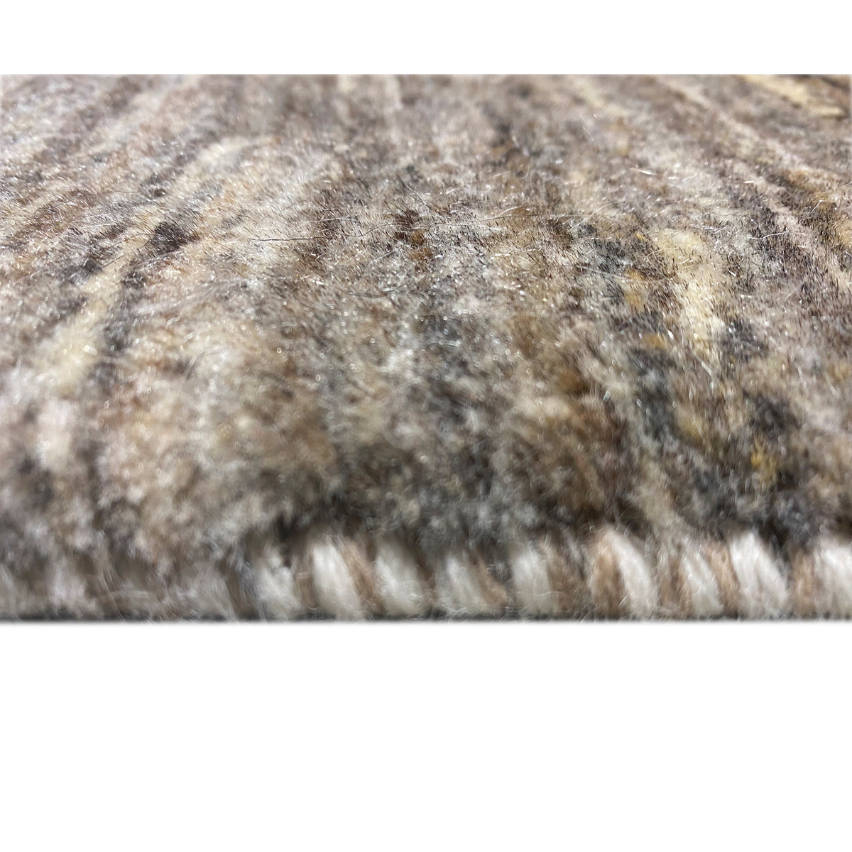 Close-up: beige, heathered carpet with a dense, textured pile surface