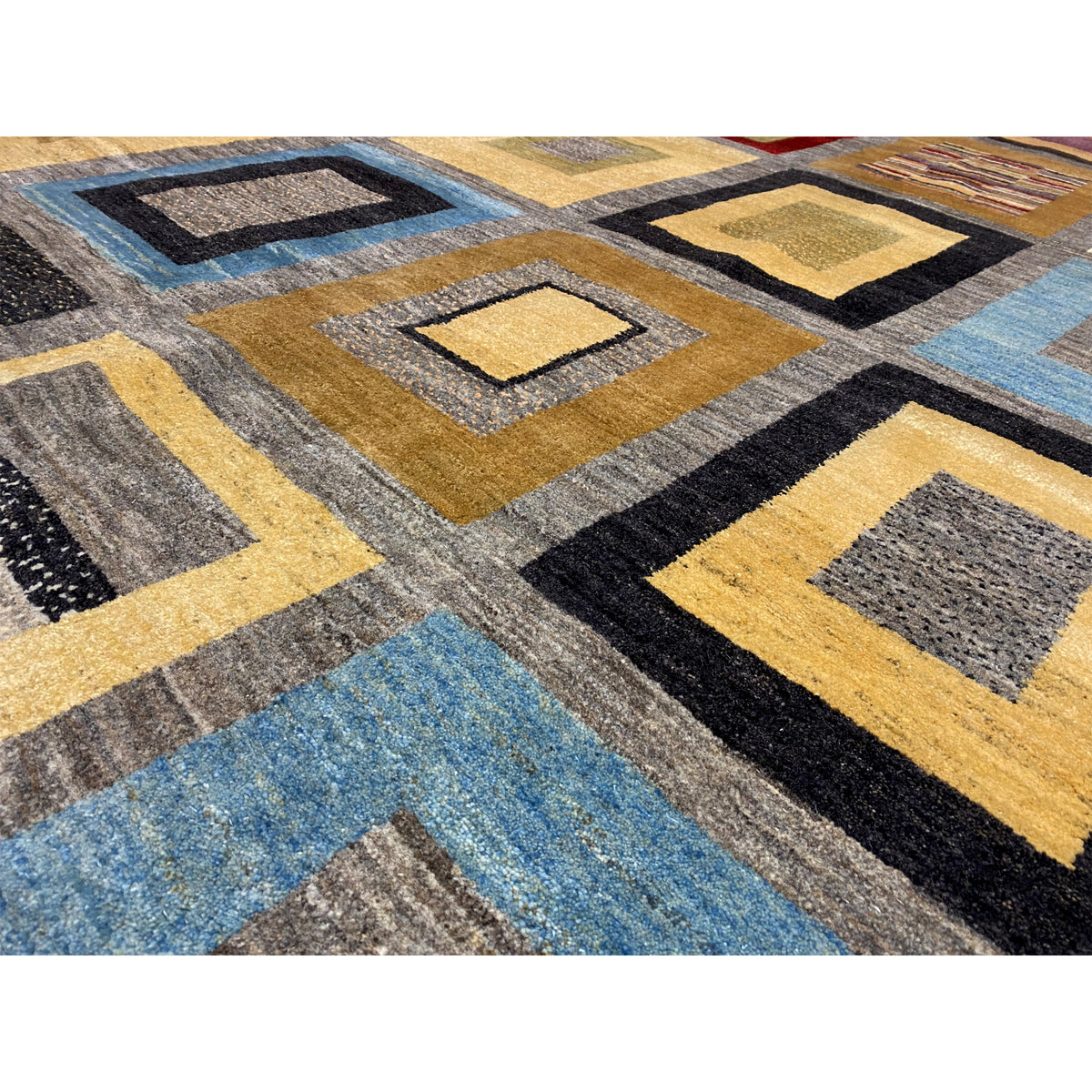 Close-up: diamonds made of multicolored yarn, with yellow, blue, and black contrasts