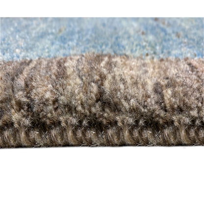 Carpet pile in detail: dense pile with multicolored fibers in blue, gray, and brown