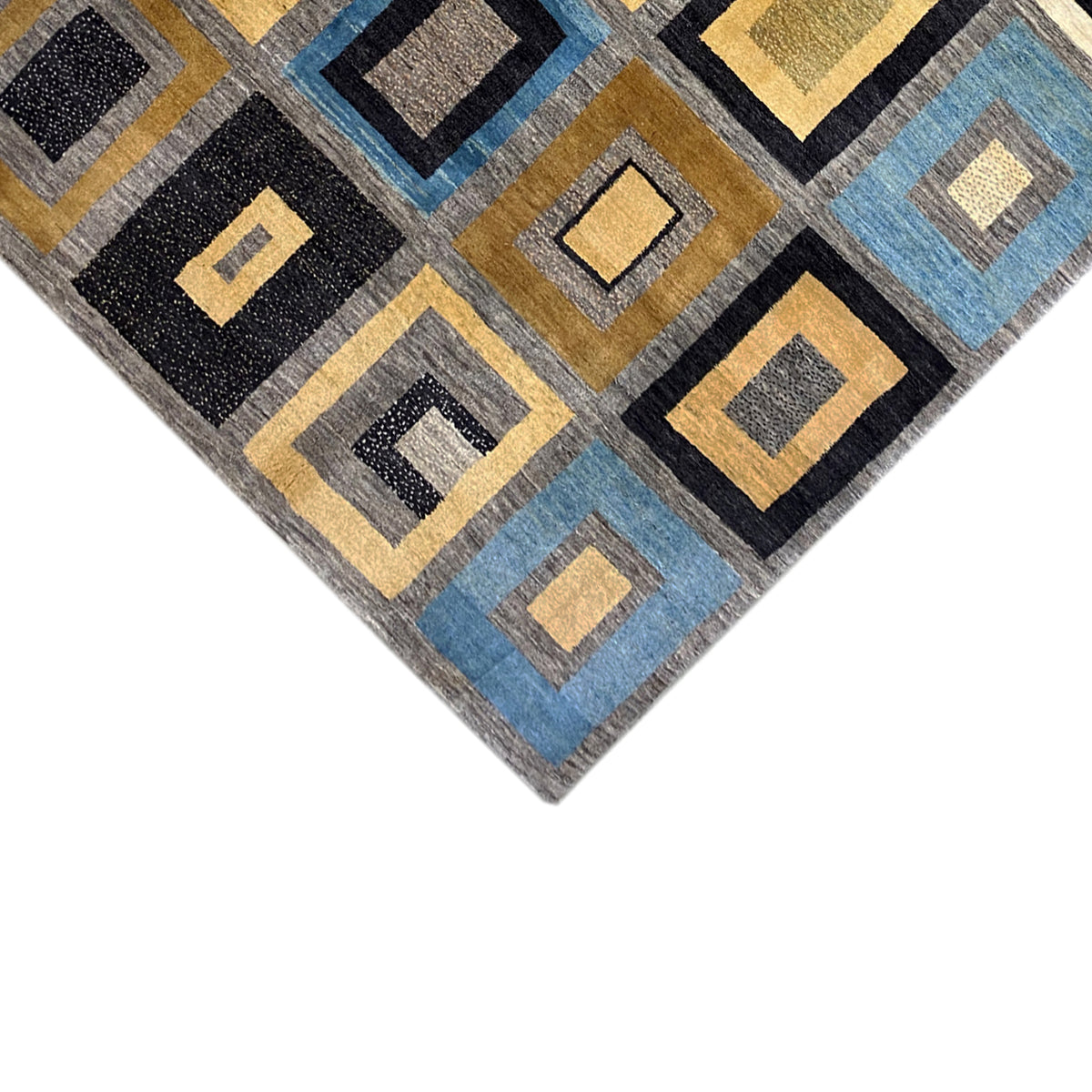 Corner of the rug with square diamond patterns, black, golden yellow, blue, and beige accents