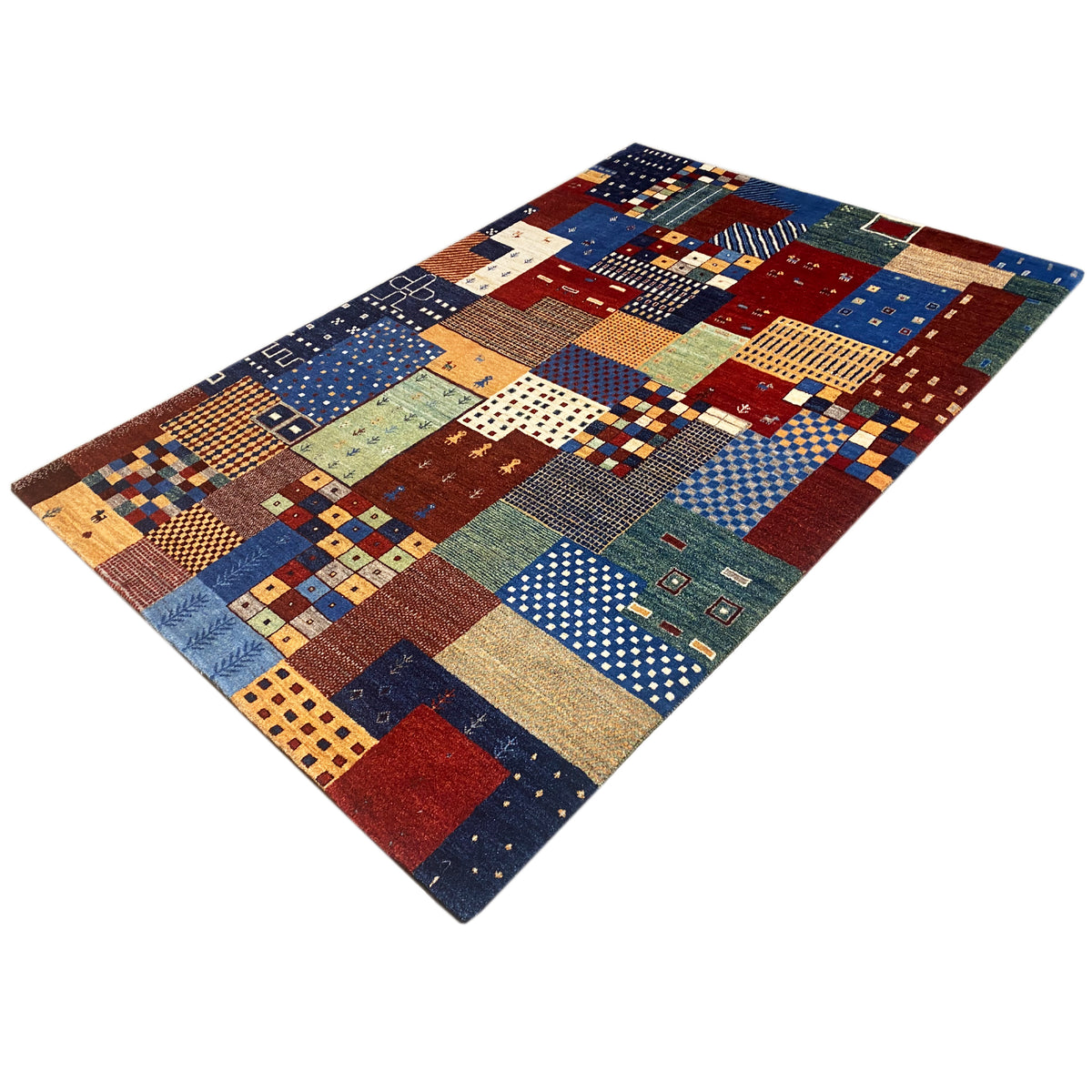 Rectangular Gabbeh rug, photographed at an angle: colorful patchwork sections with fine details