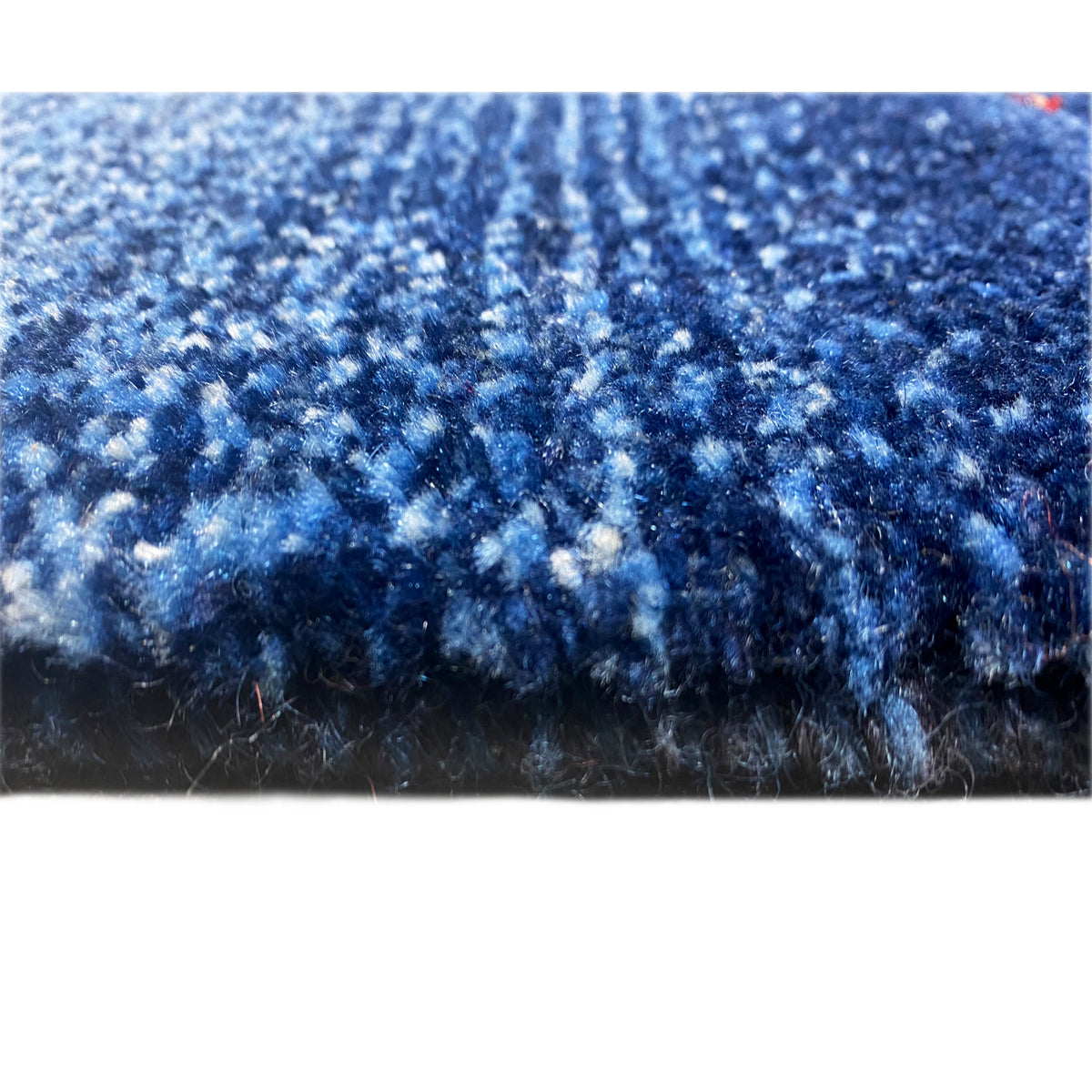 Blue Gabbeh rug in close-up: dense pile with contrasting thread edges