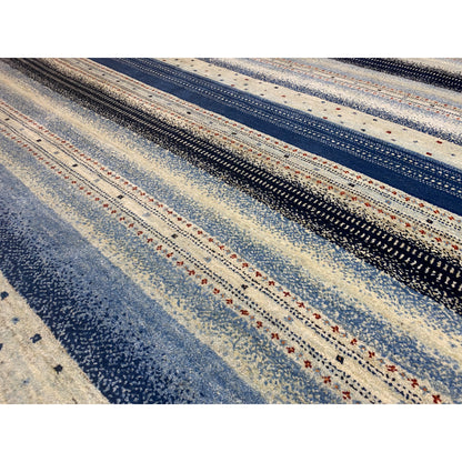 Detailed view of Gabbeh rug: fine striped pattern with small dots in blue and beige