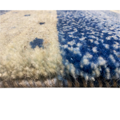 Close-up of the carpet surface: blue and beige fabric with a fluffy pile