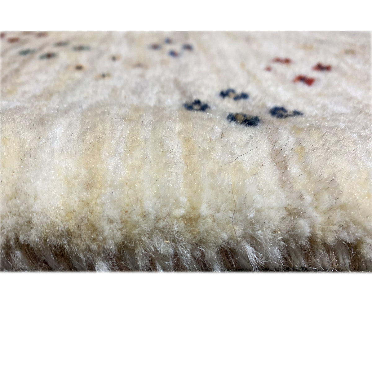 Carpet surface in close-up: soft pile in light beige with a subtle pattern