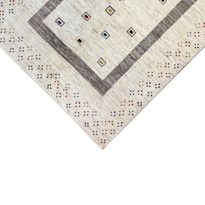 Close-up of the carpet edge with a gray central border and colorful ornamental dots