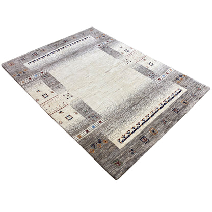 Gabbeh rug in beige and gray, diagonal view with striped textured areas