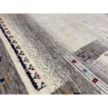 Close-up view of a Gabbeh rug: mottled texture, border with colorful small patterns