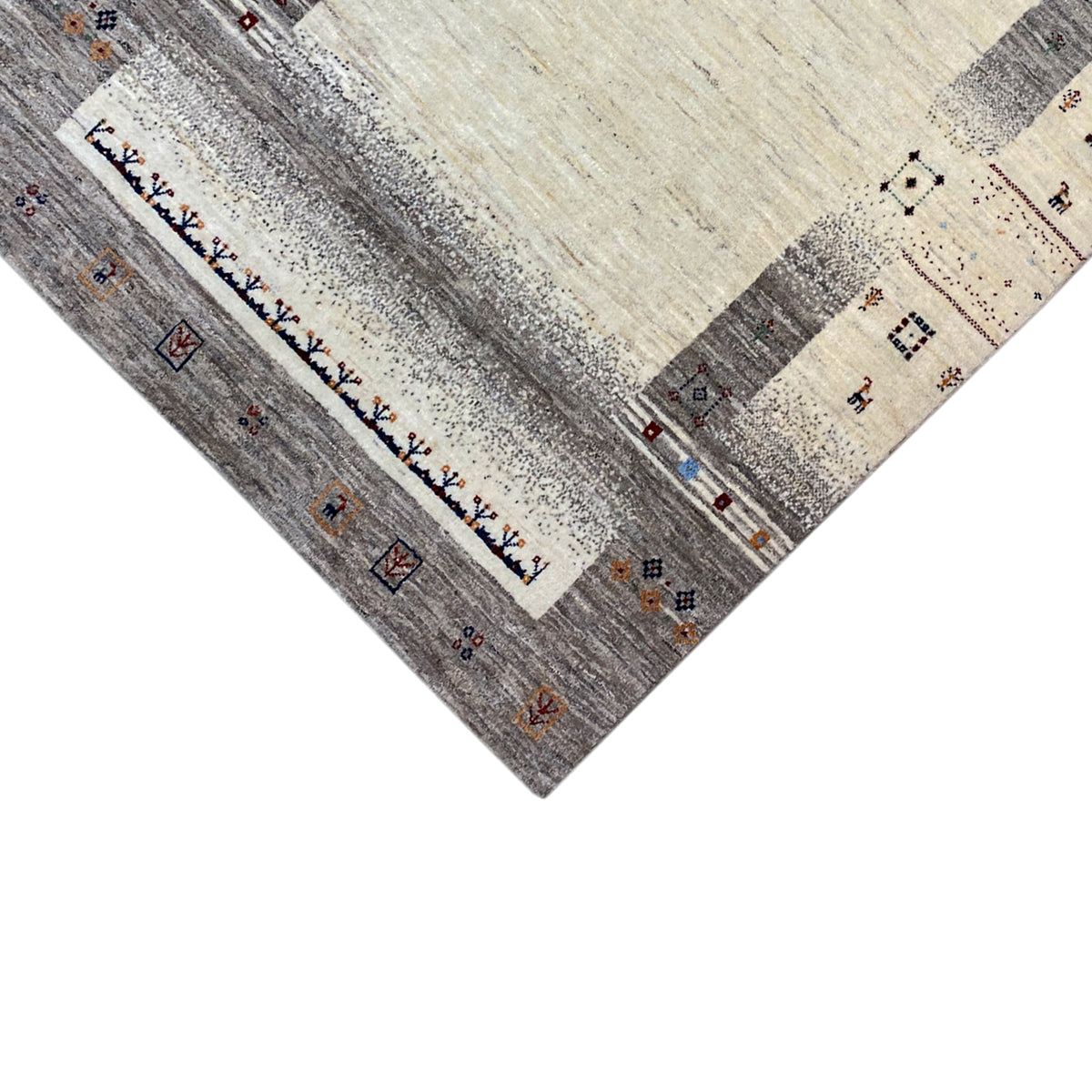 Gabbeh rug detail: border pattern, beige central area, gray zones