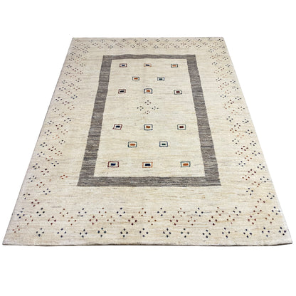 Beige gabbeh rug with a central rectangular diamond field, gray border, and fine dots