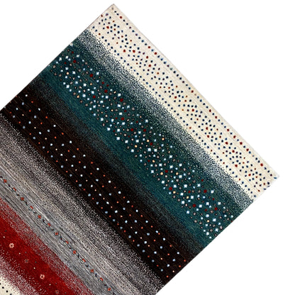 Gabbeh rug viewed from above at an angle: light border stripes, teal, and dark dots in between.